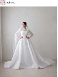 a woman in a white wedding dress with a long veil on her head and shoulders