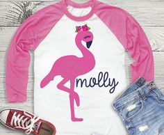 a pink and white shirt that says melly with a flamingo on it's chest