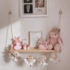 a shelf with stuffed animals and pictures on it