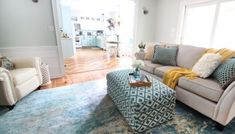 a living room filled with furniture and a blue rug