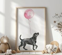 a black dog with a pink balloon in it's mouth