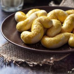 a plate full of doughnuts sitting on a table next to a glass of milk