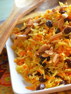 a white plate topped with rice and raisins