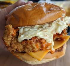 a chicken sandwich with cheese and sauce on it