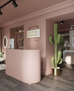 the interior of a salon with pink walls and wooden floors, large cactus in front of the counter