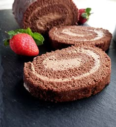 chocolate cake with strawberries on the side and one slice cut out to show it's filling