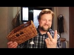 a man is holding a basket and giving the peace sign