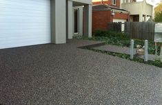 an empty driveway in front of a house