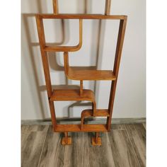 a wooden shelf sitting on top of a hard wood floor