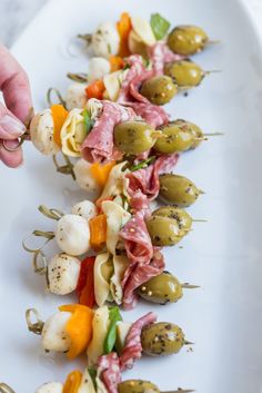 finger foods are arranged on a white plate