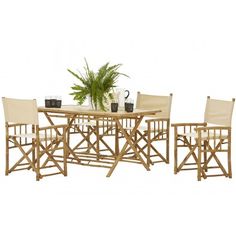 a bamboo table with four chairs and a potted plant