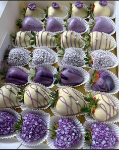 a box filled with lots of different types of chocolate covered strawberries on top of each other