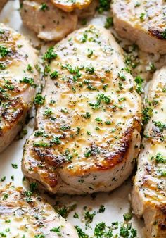 closeup of pork chops with parsley on the top and bottom of them