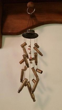 a wind chime hanging from the side of a wall