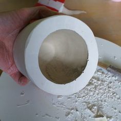 a person is pouring flour into a bowl