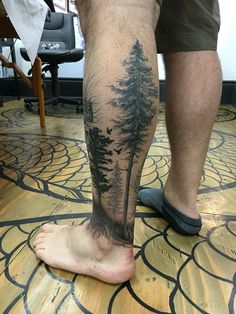 a man's foot with trees on it