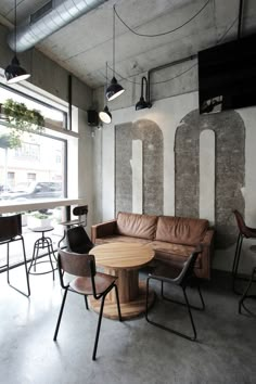 a living room filled with furniture next to a window