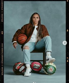 a woman sitting on top of a chair holding a basketball