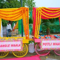 two colorful carts with orange and pink decorations on them