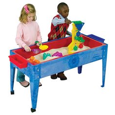 two children playing with sand and water table