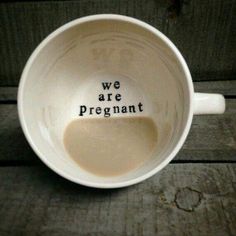 a coffee cup with the words we are pregnant written on it