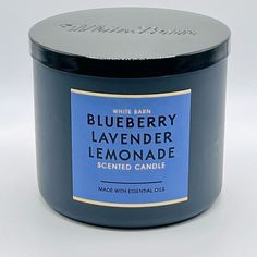 a blueberry lavender lemonade scented candle in a black glass jar on a white background