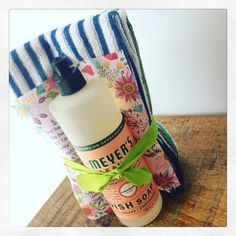 a couple of bottles sitting next to each other on top of a wooden table in front of a towel