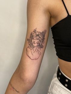 a woman with a tattoo on her arm