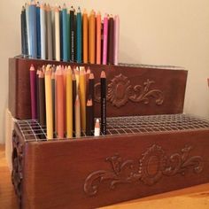 several colored pencils are lined up in a holder