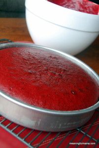 a metal pan filled with red liquid next to a white bowl