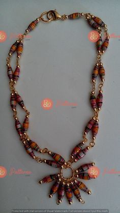 a necklace with beads and charms on it