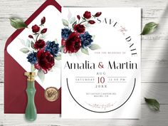 an elegant wedding card with red, white and blue flowers on it next to a green vase