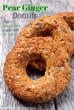 two vegan gluten - free sugar - free pear ginger donuts on a wooden table