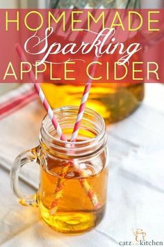 homemade sparkling apple cider recipe in a mason jar with two straws on top