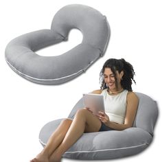 a woman sitting on an inflatable chair using a tablet