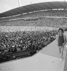 the rolling stones performing on stage in front of a large crowd at an outdoor concert