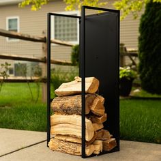 a stack of logs sitting in front of a house