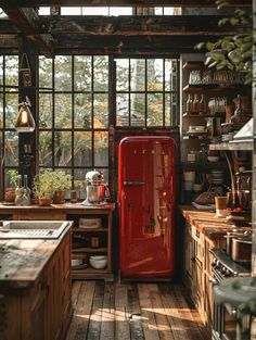 a red refrigerator sitting in the middle of a kitchen