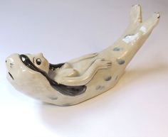 a ceramic animal figurine laying on its back