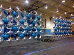 several blue vases are stacked on top of each other in the middle of a room