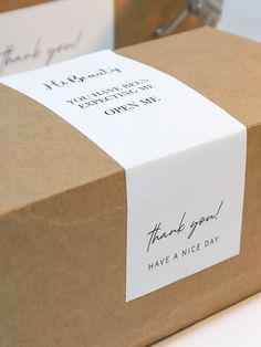 two brown boxes with thank you notes on the front and back of each box, one has a note attached to it that says thank you have a nice day