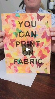 a man holding up a piece of paper with the words you can print on fabric