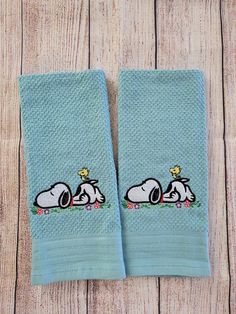 two blue towels with snoopy dogs on them