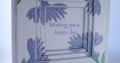 a white card with purple flowers on it and the words wishing you a happy day