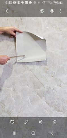 a person using a spatula to cut up something on top of a marble floor