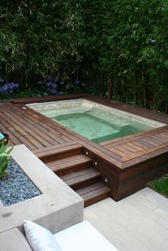 an outdoor hot tub surrounded by wooden steps