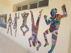 the wall is decorated with colorful art pieces