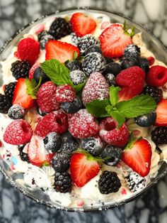 a bowl filled with berries and whipped cream