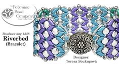 a blue and purple beaded bracelet with an ornate design on the front, and white beads