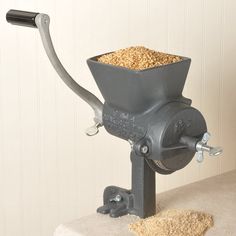 a machine that is sitting on top of a white countertop with grain in it